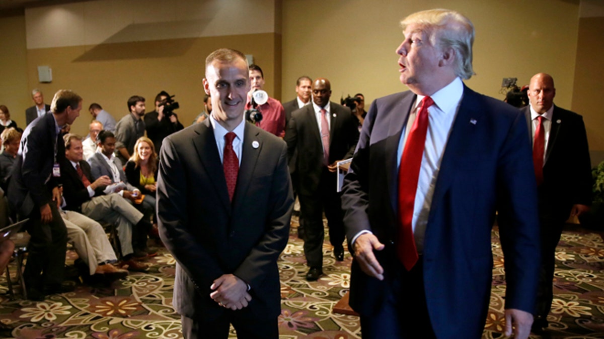 FILE - In this Aug. 25, 2015 file photo, Republican presidential candidate Donald Trump, right, walks with his campaign manager Corey Lewandowski after speaking at a news conference in Dubuque, Iowa.  Breitbart News reporter Michelle Fields, who said that she was grabbed by Lewandowski as she attempted to question Trump  in Florida on Tuesday, March 8,  has resigned from the conservative website, saying that she can't work for an organization that doesn't support her. (AP Photo/Charlie Neibergall, File)