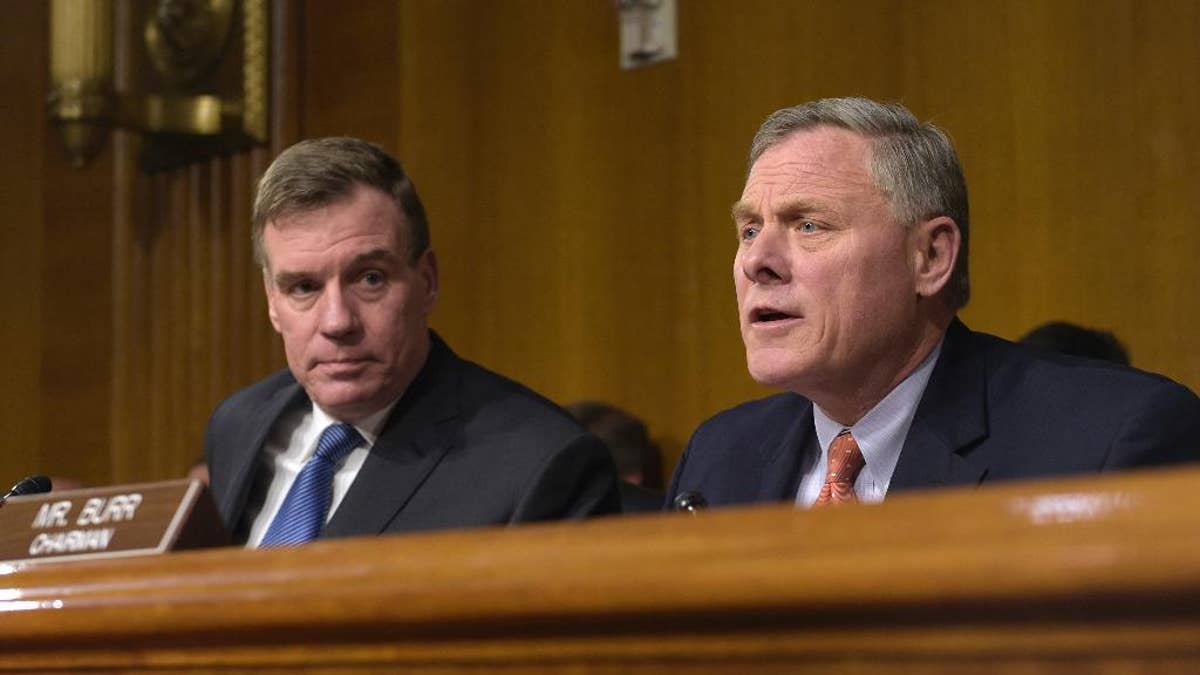Senate Intelligence Committee Chairman. Sen. Richard Burr, R-N.C., right, joined by Vice Chairman Sen. Mark Warner, D-Va., left, speaks at the Senate Intelligence Committee hearing on Capitol Hill in Washington, Thursday, March 30, 2017. Lawmakers heading the Senate intelligence committee focused squarely on Russia as they opened a hearing Thursday on attempts at undermining the 2016 U.S. presidential election. (AP Photo/Susan Walsh)