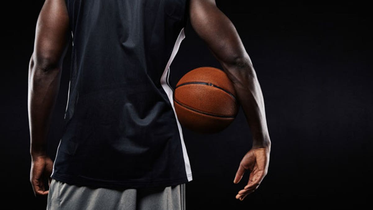 African basketball player with a ball in his arm