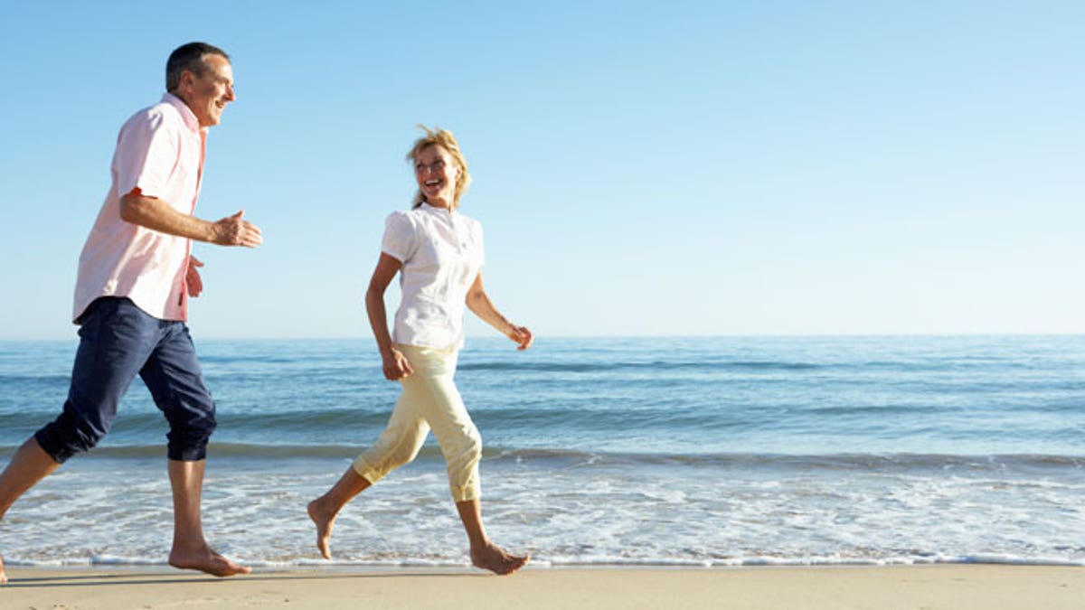 Senior Couple Enjoying Romantic Beach Holiday