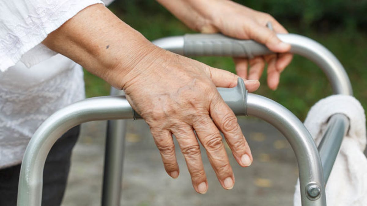 Senior woman using a walker cross street