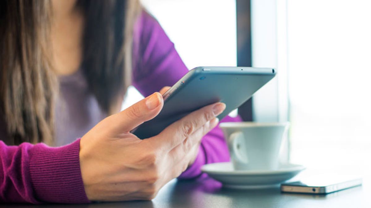 Woman using iPhone and iPad Mini