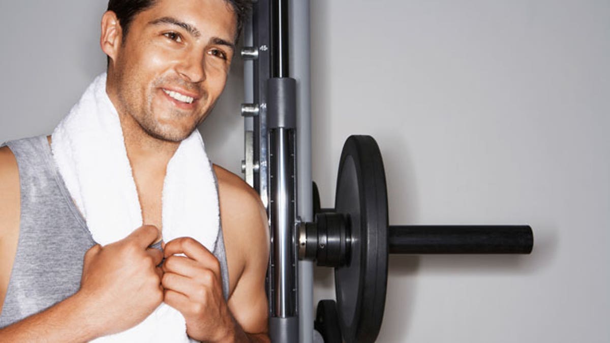 Happy Man Resting On Barbell After Workout