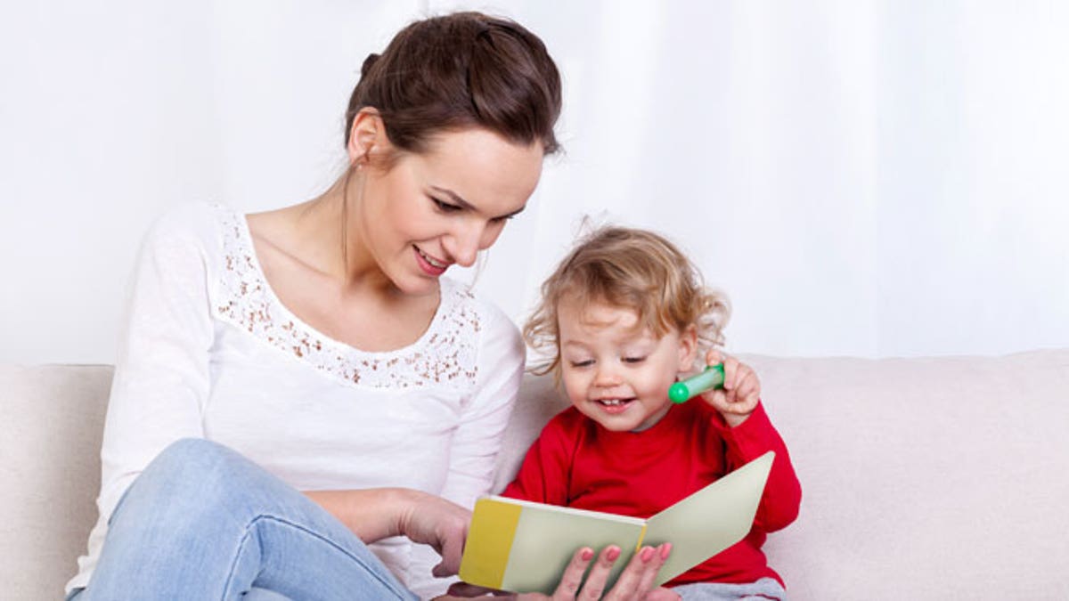 Mother reading book with child