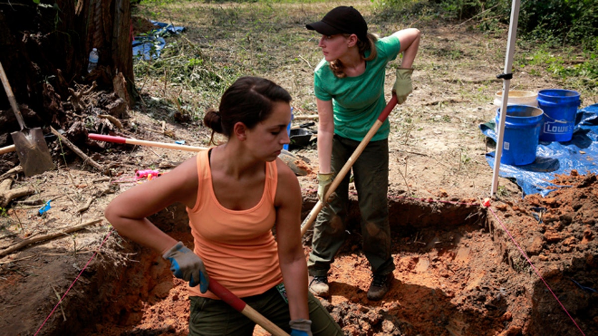 Aug. 31, 2013: University of South Florida masters student Cristina Kelbaugh, left, and PhD student Ashley Maxwell, 27, dig at the Boot Hill cemetery at the closed Arthur G. Dozier School for Boys in Marianna, Fla.