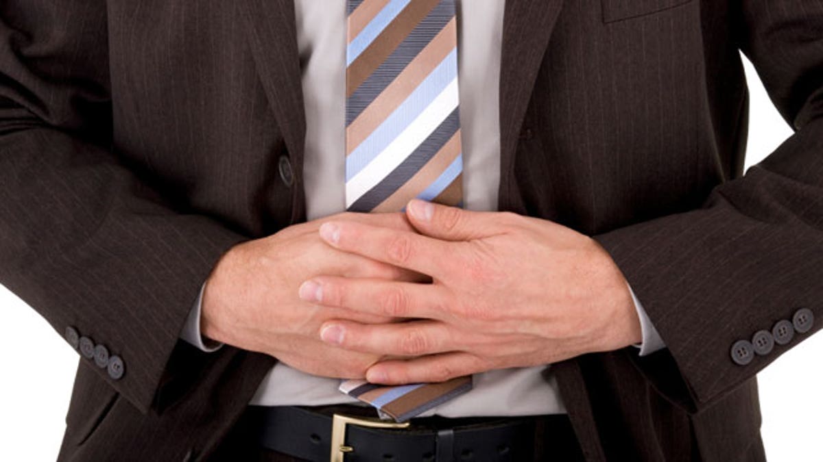67763bd8-Businessman with stomach ache