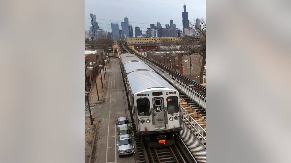 A Chicago Transit Authority Green Line train travels West away from downtown Chicago, Thursday, March 23, 2017, in Chicago. Chicago had the biggest population drop among major metropolitan areas, according to new Census data, part of a years-long decline for the region. (AP Photo/Charles Rex Arbogast)