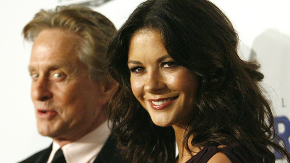 Michael Douglas, left, and wife Catherine Zeta-Jones, right, are completely on board with working together now that they're "pretty much empty-nesters."