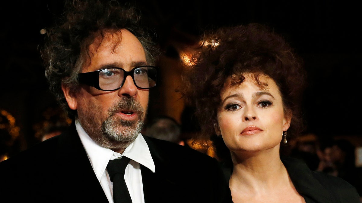 Film director Tim Burton and his wife actress Helena Bonham Carter arrive for the European premiere of his film 