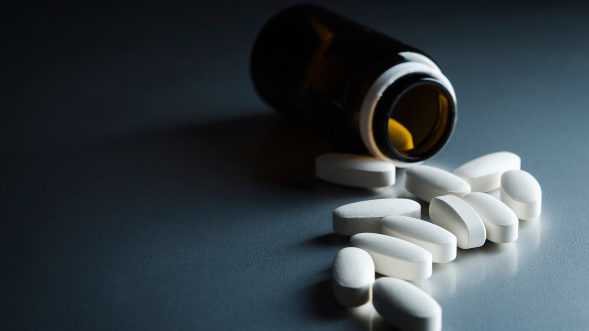 medical bottle and pills on background