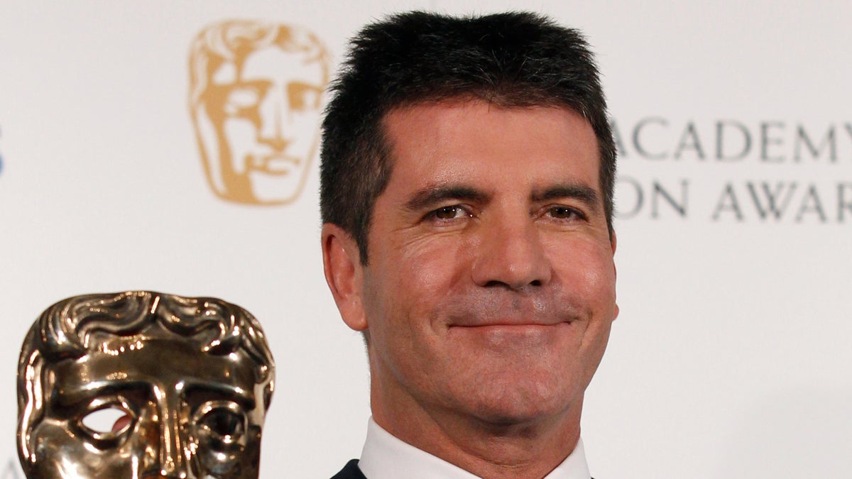 Television mogul Simon Cowell poses after receiving the British Academy Television Awards Special Award at the Palladium Theatre in London June 6, 2010. REUTERS/Luke MacGregor (BRITAIN - Tags: ENTERTAINMENT PROFILE SOCIETY)
