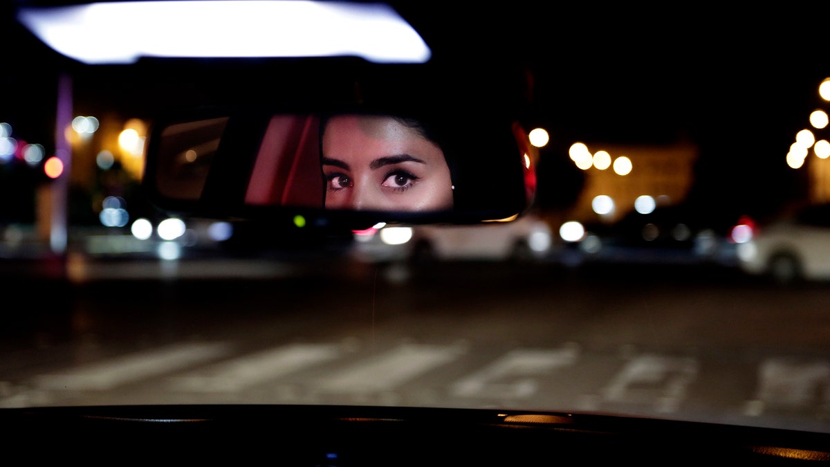 FILE - In this Sunday, June 24, 2018 file photo, Hessah al-Ajaji drives her car down the capital's busy Tahlia Street after midnight for the first time, in Riyadh, Saudi Arabia. Saudi women are driving freely for the first time after years of risking arrest if they dared to get behind the wheel. And with the ban now lifted, a new opportunity has emerged: Working as drivers. (AP Photo/Nariman El-Mofty, File)