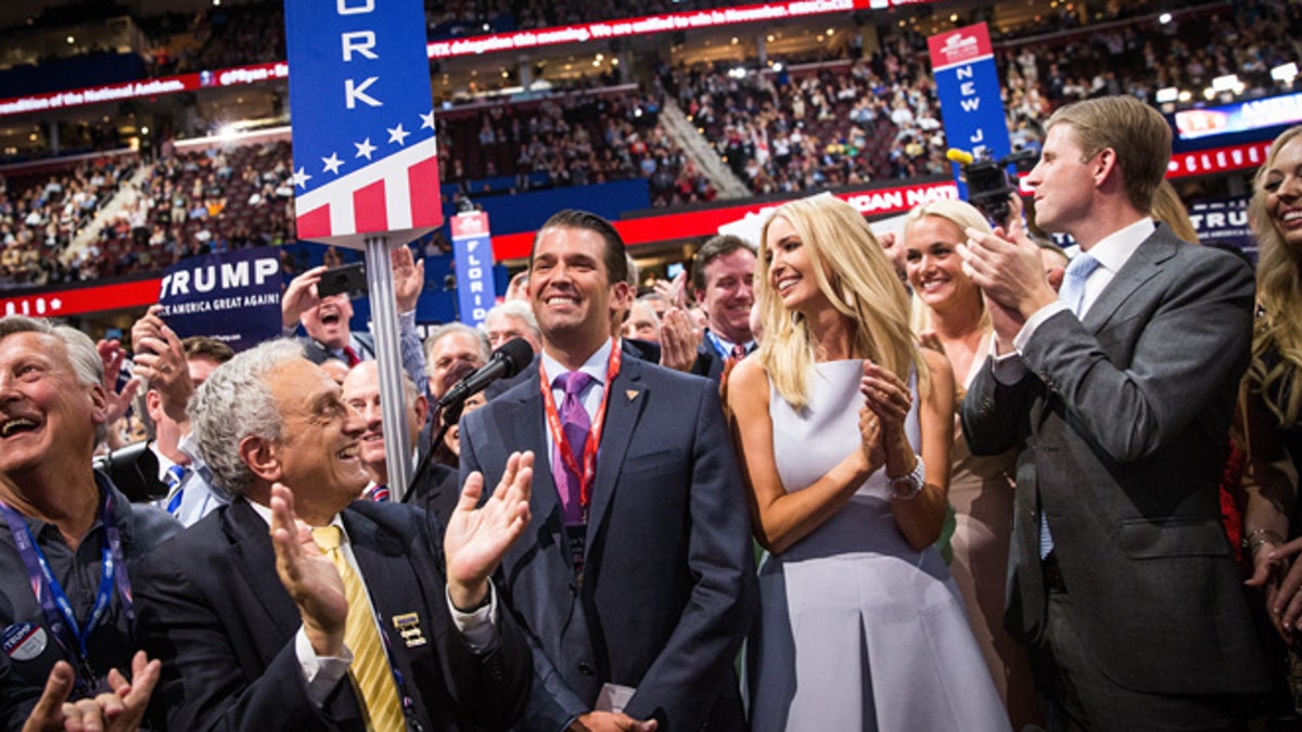 New York delegate Donald Trump, Jr., center, announces New York's vote, clinching the nomination for his father at the 2016 Republican National Convention in Cleveland, Ohio, July 19, 2016.