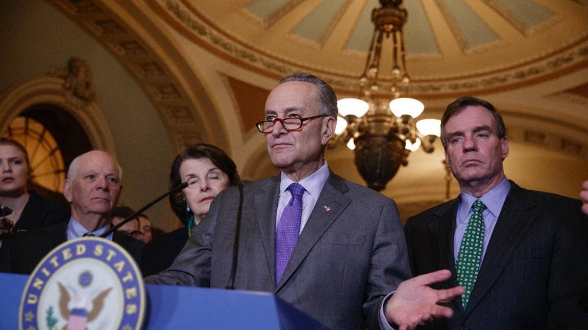 Senate Minority Leader Chuck Schumer, D-N.Y, joined by, from left, Sen. Ben Cardin, D-Md., the ranking member on the Foreign Relations Committee, Sen. Dianne Feinstein, D-Calif., the ranking member of the Senate Judiciary Committee, and Sen. Mark Warner, D-Va., vice chair of the Intelligence Committee, right, calls for an investigation into President Donald Trump's administration over its relationship with Russia, including when Trump learned that his national security adviser, Michael Flynn, had discussed U.S. sanctions with a Russian diplomat, Wednesday, Feb. 15, 2017, on Capitol Hill in Washington. (AP Photo/J. Scott Applewhite)