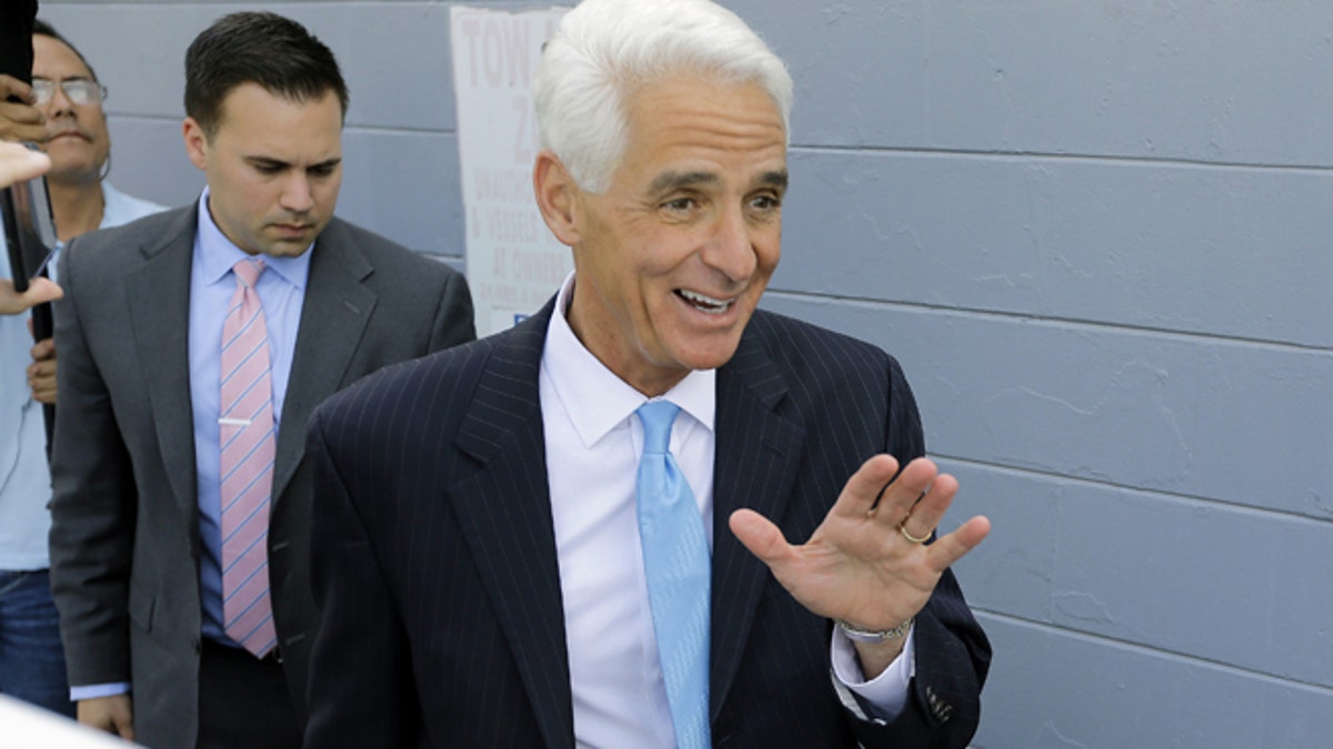 Florida Democratic gubernatorial candidate Charlie Crist waves as he arrives to meet supporters at a phone bank during a campaign stop Tuesday, Nov. 4, 2014 in Tampa, Fla. Crist is running against Gov. Rick Scott. (AP Photo/Chris O'Meara)