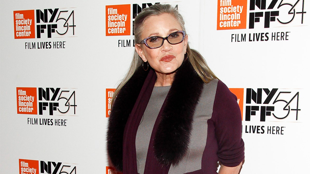 FILE - In this Monday, Oct. 10, 2016, file photo, actress Carrie Fisher attends a special screening of, "Bright Lights: Starring Carrie Fisher and Debbie Reynolds," at Alice Tully Hall in New York. J.J. Abrams says he will use unreleased footage of Fisher in the next "Star Wars" film to give the latest trilogy a "satisfying conclusion." Lucasfilm and writer-director Abrams announced Friday, July 27, 2018, that footage Fisher shot for 2015's "Star Wars: The Force Awakens" will be used in the ninth film in the space opera's core trilogies about the Skywalker family. (Photo by Andy Kropa/Invision/AP, File)