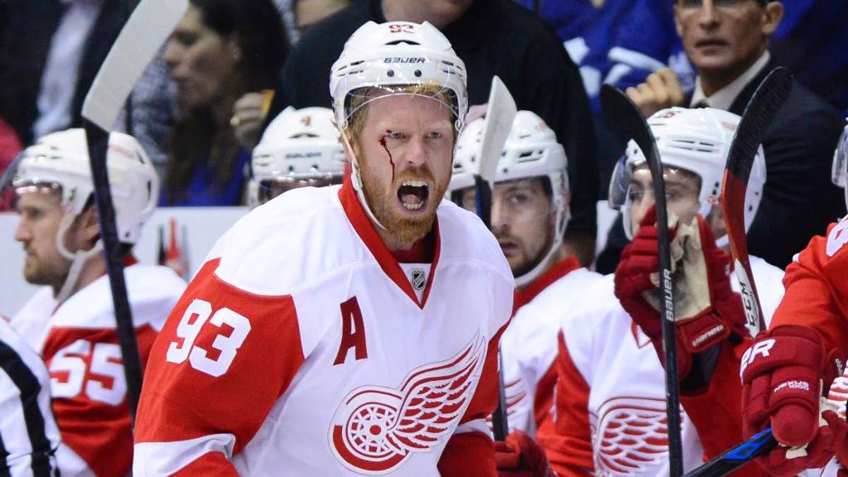 Detroit Red Wings' Detroit Red Wings' Johan Franzen yells at the referee after taking a hit to the head against the Toronto Maple Leafs during first-period NHL hockey game action in Toronto, Friday, Oct. 17, 2014. (AP Photo/The Canadian Press, Frank Gunn)