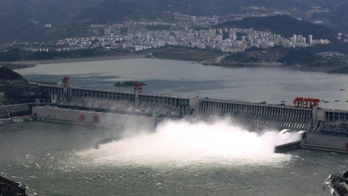 In this Nov. 7, 2008 photo, flow of water is discharged through the Three Gorges Dam in Yichang in central China's Hubei province. State-owned China Three Gorges Group is spending heavily to buy or build hydro, wind and solar projects at a time when Western utility investors are pulling back and U.S. President-elect Donald Trump’s pledge to revive coal use has raised doubt about U.S. support for renewables. (Chinatopix via AP)