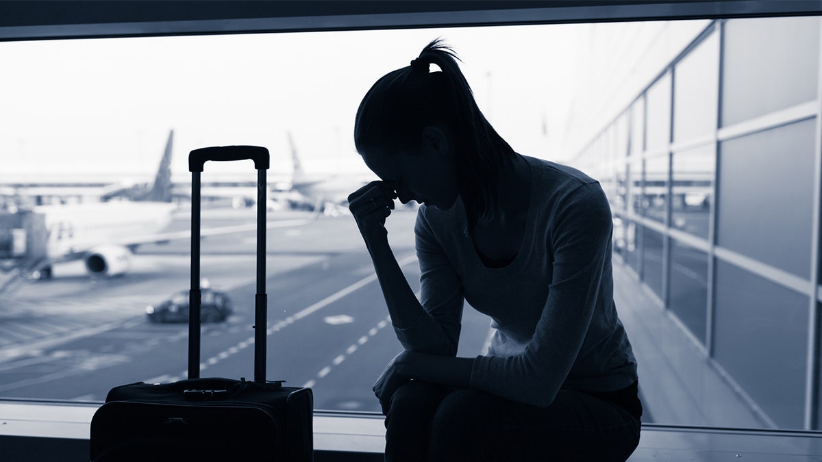 sad woman airport