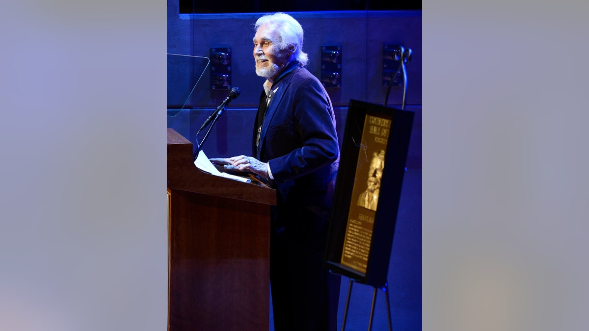 Country music star Kenny Rogers gives his acceptance speech at the ceremony for the 2013 inductions into the Country Music Hall of Fame on Sunday, Oct. 27, 2013, in Nashville, Tenn. The inductees are Bobby Bare, the late Cowboy Jack Clement and Kenny Rogers. (AP Photo/Mark Zaleski)