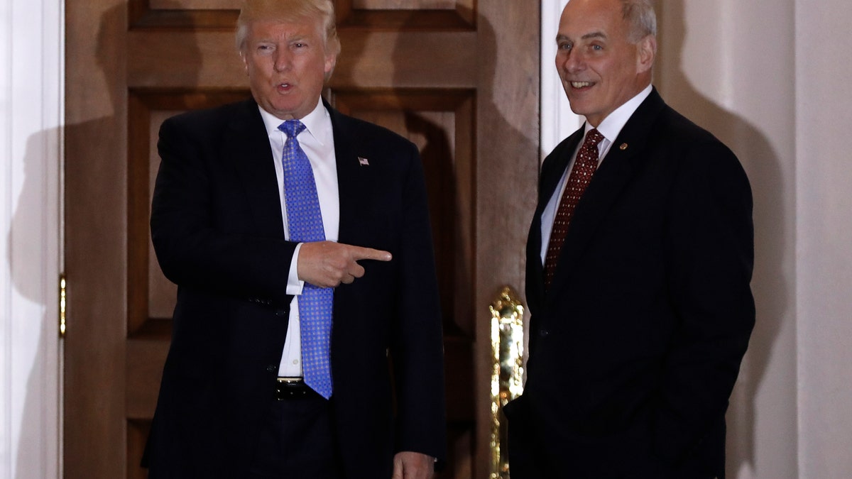 FILE - In this Nov. 20, 2016 file photo, President-elect Donald Trump talks to media as he stands with retired Marine Gen. John Kelly, at the Trump National Golf Club Bedminster clubhouse in Bedminster, N.J. Trump is tapping another four-star military officer for his administration. He has picked Kelly to lead the Homeland Security Department, according to people close to the transition. (AP Photo/Carolyn Kaster, File)