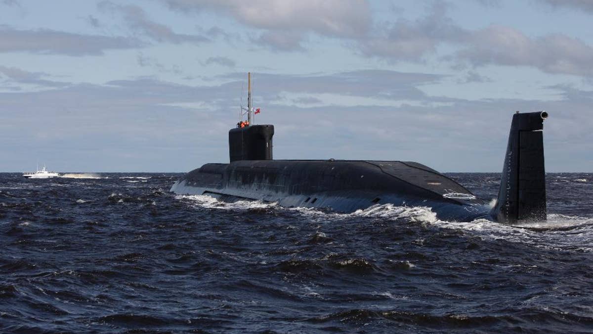 FILE - in this file photo taken on Thursday, July 2, 2009, the Russian nuclear submarine, Yuri Dolgoruky, is seen during sea trials near Arkhangelsk, Russia. The Russian navy said in a statement Friday March 31, 2017, that its submarines have increased combat patrols to the level last seen during the Cold War. (AP Photo/Alexander Zemlianichenko, File)
