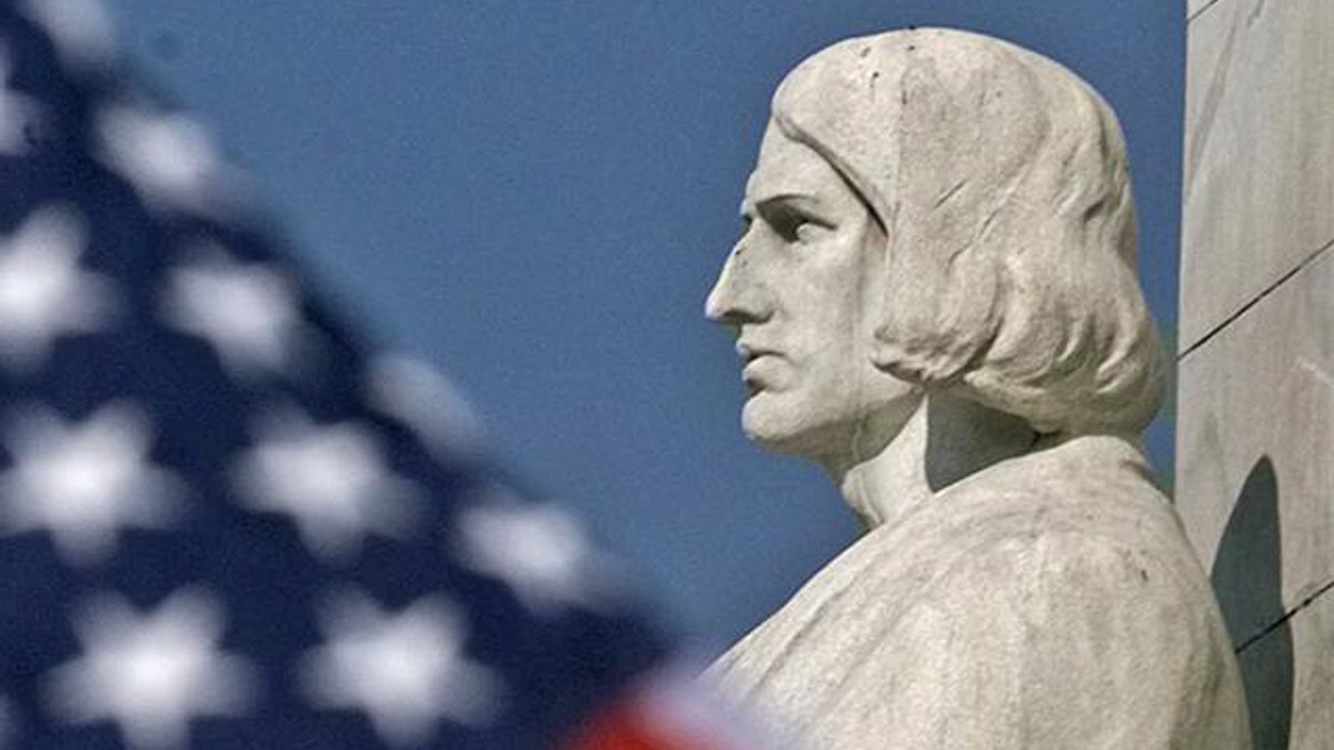 An American flag flies near the Christopher Columbus statue outside Washington's Union Station, Monday Oct. 11, 1999, during the city's annual Columbus Day ceremony. (AP Photo)