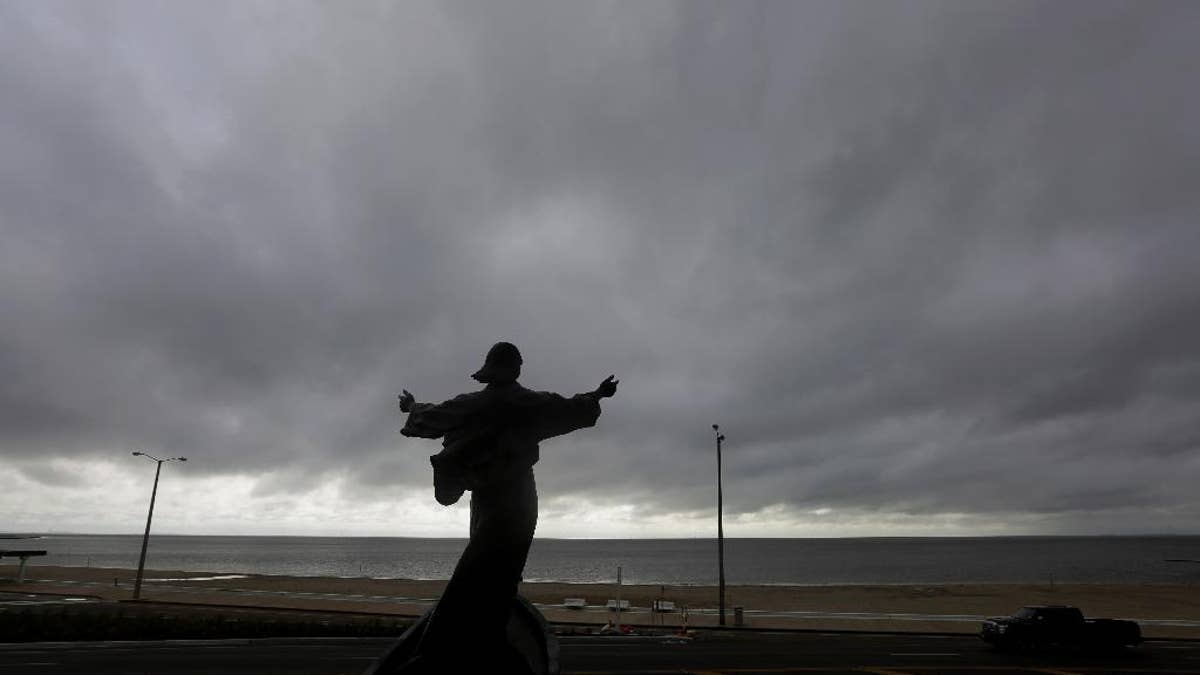 A statue of Jesus calming the sea titled "It is I" faces the bay and gulf, in Corpus Christi, Tuesday, June 16, 2015, as Tropical Storm Bill begins to make landfall. The National Hurricane Center in Miami says Tropical Storm Bill came ashore Tuesday morning in the area of Matagorda County, about 90 miles southwest of Houston. (AP Photo/Eric Gay)
