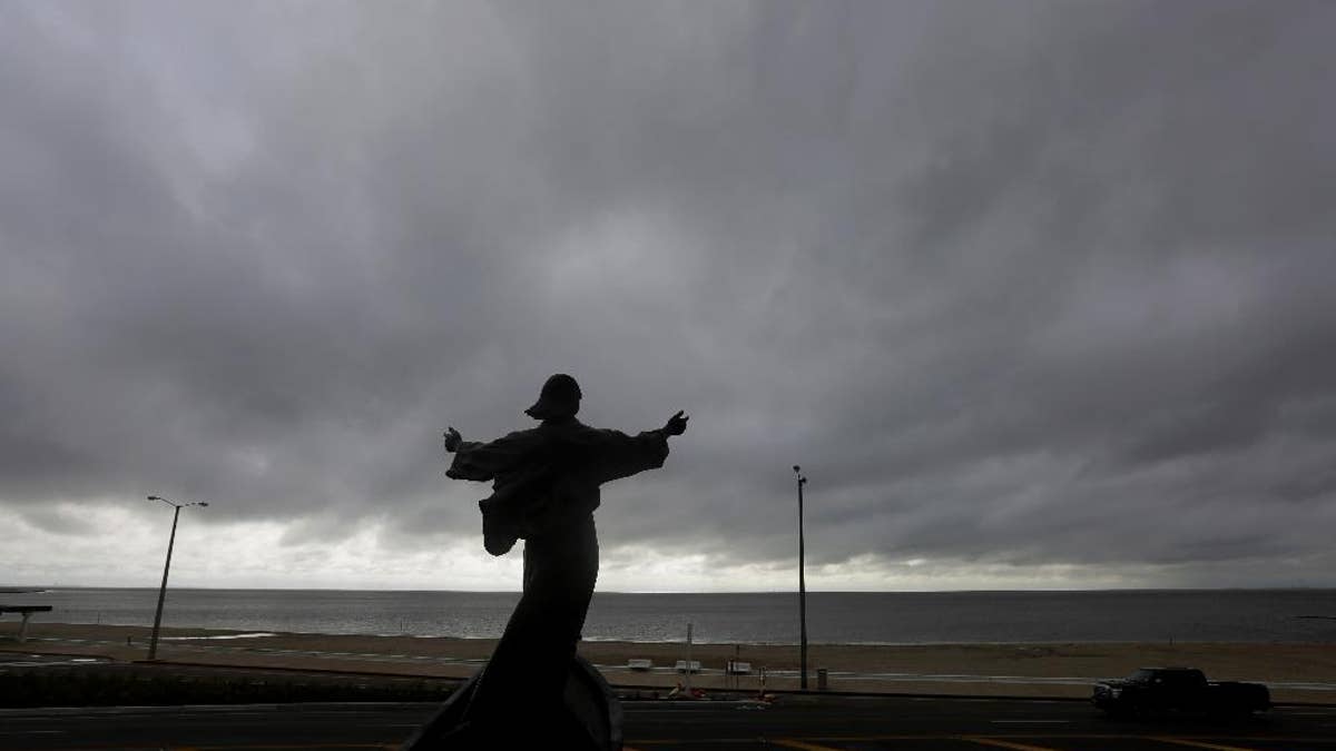 A statue of Jesus calming the sea titled "It is I" faces the bay and gulf, in Corpus Christi, Tuesday, June 16, 2015, as Tropical Storm Bill begins to make landfall. The National Hurricane Center in Miami says Tropical Storm Bill came ashore Tuesday morning in the area of Matagorda County, about 90 miles southwest of Houston. (AP Photo/Eric Gay)