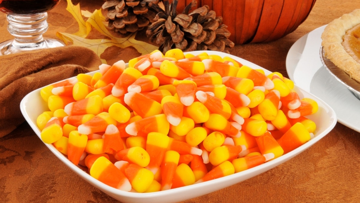 A bowl of candy corn with other Halloween or Thanksgiving treats