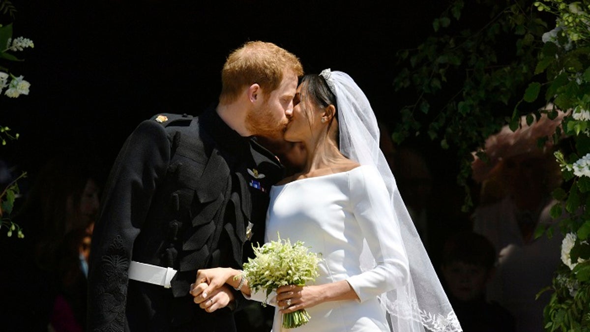 FILE - In this file photo dated Saturday, May 19, 2018, Britain's Prince Harry and Meghan Markle leave after their wedding ceremony at St. George's Chapel in Windsor Castle, in Windsor, England.  Meghan Markle has revealed in a television documentary aired Sunday Sept. 23, 2018, that she had a piece of blue fabric from the dress she wore on her first date with Harry sewn into her wedding outfit. (Ben Birchhall/pool via AP, FILE)