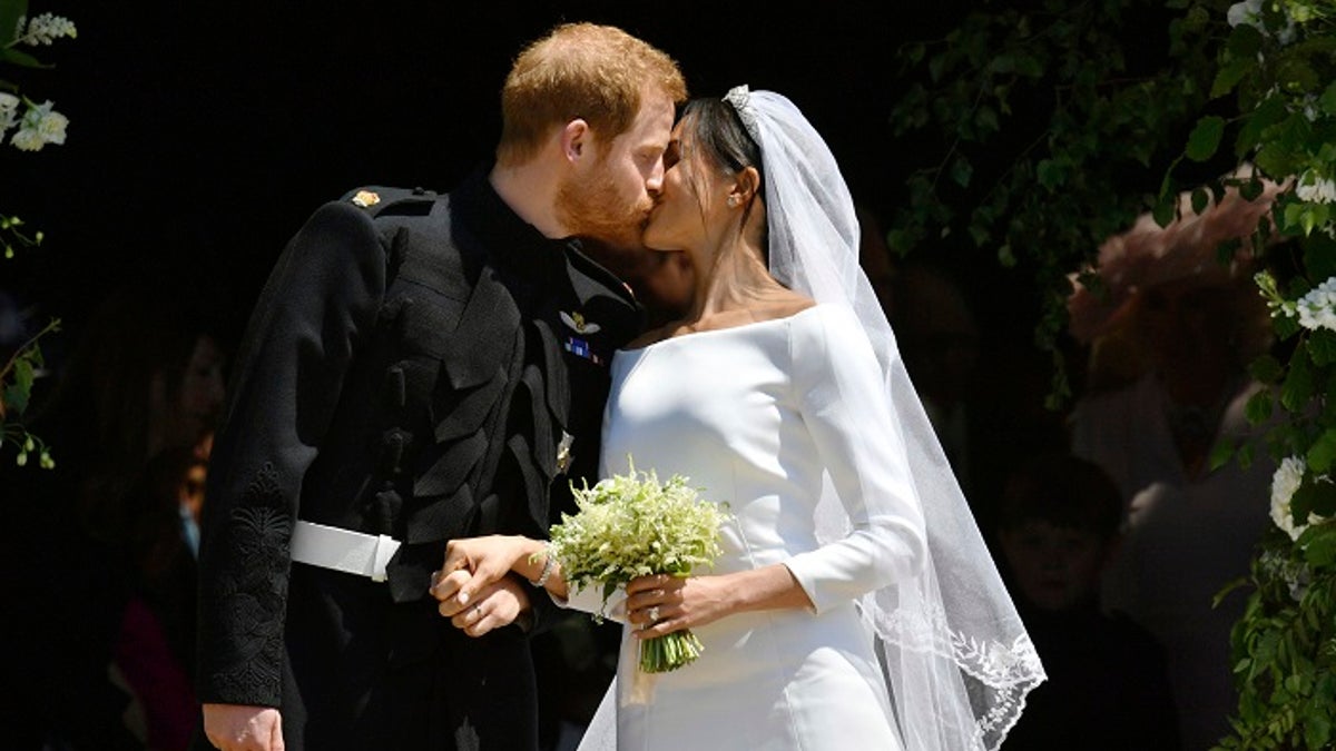 FILE - In this file photo dated Saturday, May 19, 2018, Britain's Prince Harry and Meghan Markle leave after their wedding ceremony at St. George's Chapel in Windsor Castle, in Windsor, England.  Meghan Markle has revealed in a television documentary aired Sunday Sept. 23, 2018, that she had a piece of blue fabric from the dress she wore on her first date with Harry sewn into her wedding outfit. (Ben Birchhall/pool via AP, FILE)