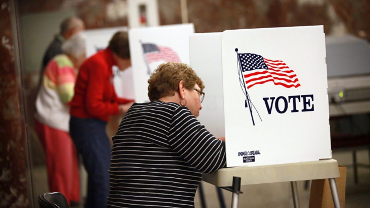 WATERLOO, IA - SEPTEMBER 27: Residents fill in their ballots during early voting at the Black Hawk County Courthouse on September 27, 2012 in Waterloo, Iowa. Early voting starts today in Iowa where in the 2008 election 36 percent of voters cast an early ballot. (Photo by Scott Olson/Getty Images)