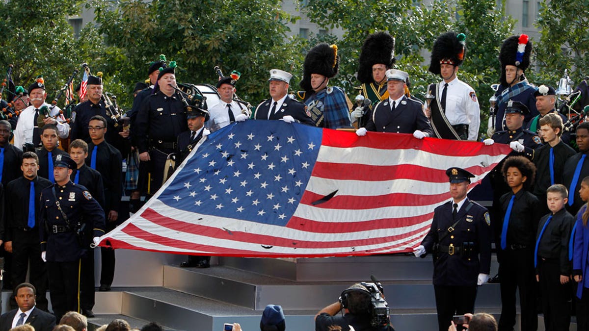 Sept. 11: The World Trade Center Flag is presented as friends and relatives of the victims of 9/11 gather for a ceremony marking the 10th anniversary of the attacks at the National September 11 Memorial at the World Trade Center site in New York.