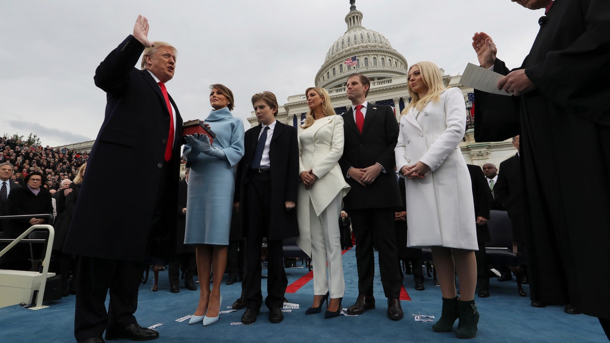 President Donald Trump takes the oath of office from Chief Justice John Roberts, as his wife Melania holds the bible, and with his children Barron, Ivanka, Eric and Tiffany, Friday, Jan. 27, 2017 on Capitol Hill in Washington. (Jim Bourg/Pool Photo via AP)