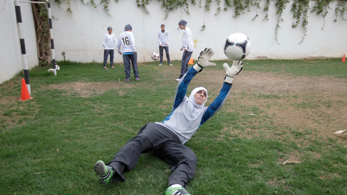 FILE - In this May 21, 2012 photo, Mawada Chaballout, a 27-year-old American member of a Saudi female soccer team practices at a secret location in Riyadh, Saudi Arabia. Saudi Arabia’s official press agency says the Education Ministry has allowed private female schools to hold sports activities within the Islamic Sharia laws. SPA said Saturday, May 4, 2013 that the ministry issued directives ordering private female schools to provide appropriate places and equipment for such activities, adhere to wearing decent dress and that Saudi women teachers should be given priority in supervising these activities.(AP Photo/Hassan Ammar, File)