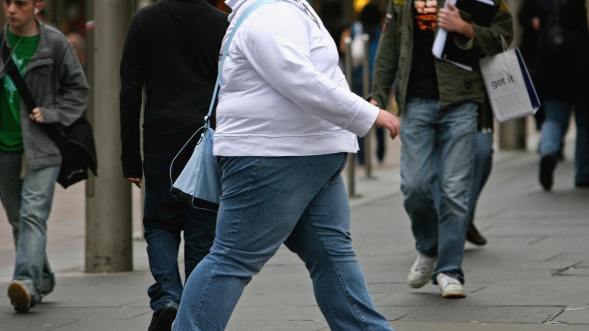 GLASGOW, UNITED KINGDOM - OCTOBER 10: An overweight person walks through Glasgow city centre on October 10, 2006 in Glasgow, Scotland. According to government health maps published today, people in the north of England lead less healthy lifestyles compared to those in the south. The United Kingdom is also the fattest country in Europe, according to a new study of obesity rates to be released today. The "Health Profile of England" report, compiled from government data, said some 24 percent of people in England, Wales, Scotland and Northern Ireland are obese. (Photo by Jeff J Mitchell/Getty Images)