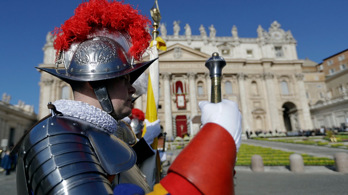 Vatican Swiss Guards stand at attention in front of St. Peter's Basilica at the Vatican prior to the arrival of Pope Francis to celebrate an Easter mass, Sunday, April 1, 2018. (AP Photo/Andrew Medichini)