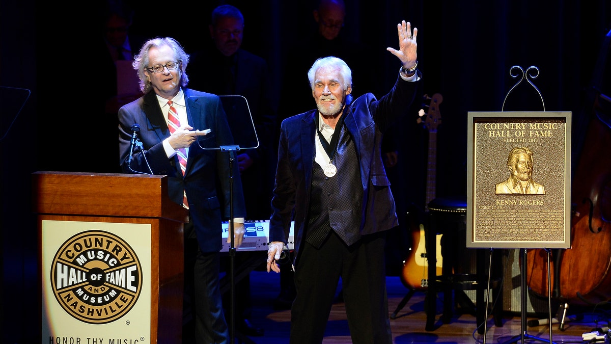 Country music star Kenny Rogers thanks the audience at the ceremony for the 2013 inductions into the Country Music Hall of Fame on Sunday, Oct. 27, 2013, in Nashville, Tenn. The inductees are Bobby Bare, the late Cowboy Jack Clement and Kenny Rogers. (AP Photo/Mark Zaleski)