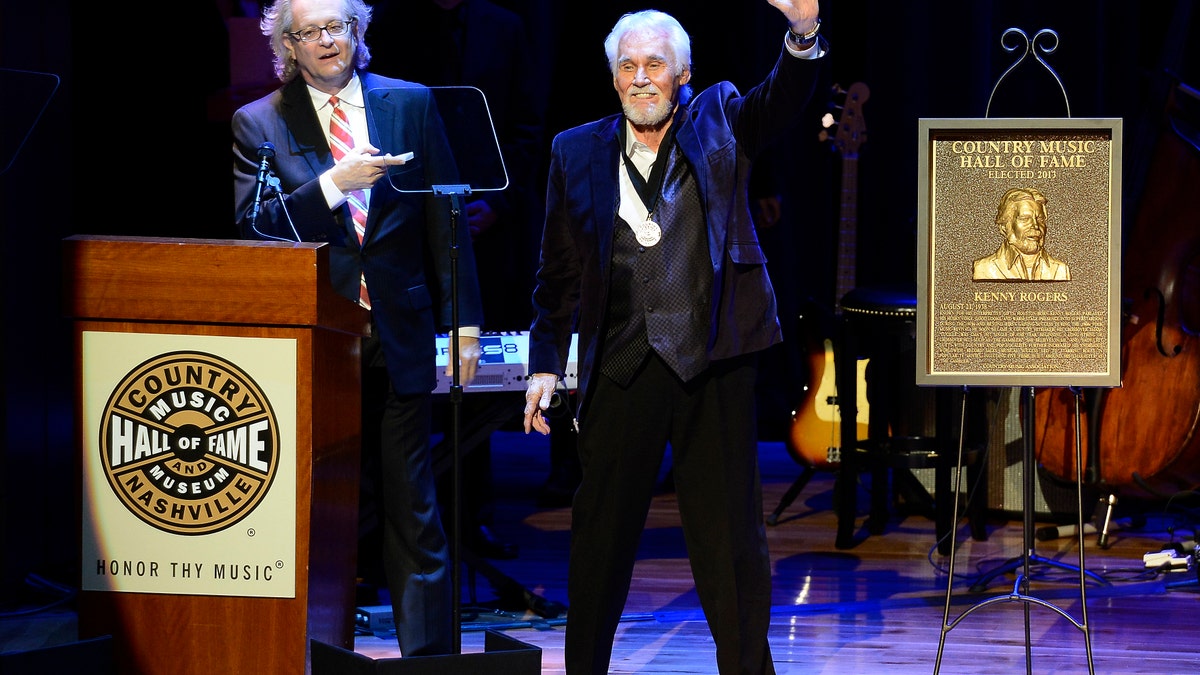 Country music star Kenny Rogers thanks the audience at the ceremony for the 2013 inductions into the Country Music Hall of Fame on Sunday, Oct. 27, 2013, in Nashville, Tenn. The inductees are Bobby Bare, the late Cowboy Jack Clement and Kenny Rogers. (AP Photo/Mark Zaleski)