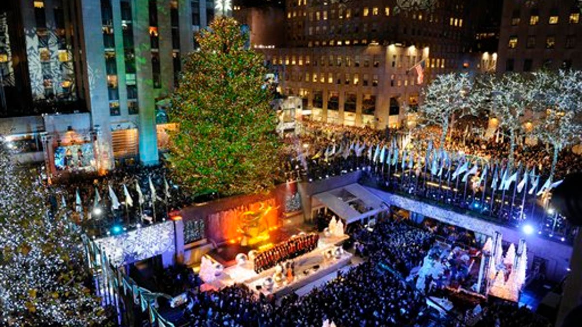 The 74-foot-tall Rockefeller Center Christmas Tree is lit by 30,000 energy efficient LED lights in the 79th annual lighting ceremony, Wednesday, Nov. 30, 2011 in New York. (AP Photo/Henny Ray Abrams)