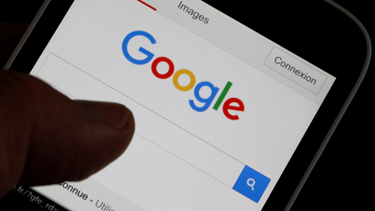 A man holds his smartphone which displays the Google home page, in this picture illustration taken in Bordeaux, Southwestern France, August 22, 2016. REUTERS/Regis Duvignau - RTX2MKPM