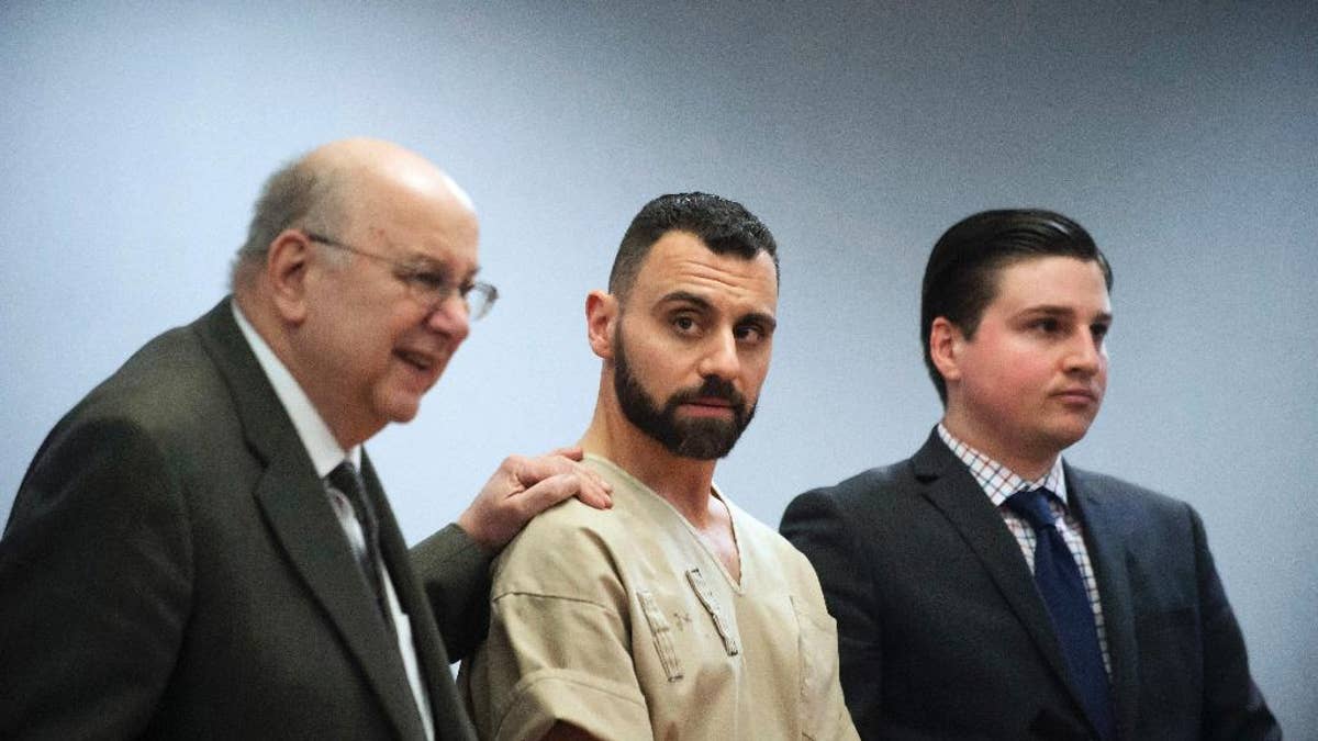 FILE - In this Monday, April 17, 2017, file photo, Richard Dabate, center, appears with attorneys Hubie Santos, left, and Trent LaLima, right, while being arraigned, in Rockville Superior Court in Vernon, Conn. Authorities said Dabate told them a masked man had entered their home Dec. 23, 2015, shot his wife and tied him up before he burned the intruder with a torch. But the New York Daily News reported the Connecticut State Police wrote in an arrest warrant that his wife’s Fitbit was logging steps after the time Dabate told them she was killed. (Mark Mirko/Hartford Courant via AP, Pool, File)