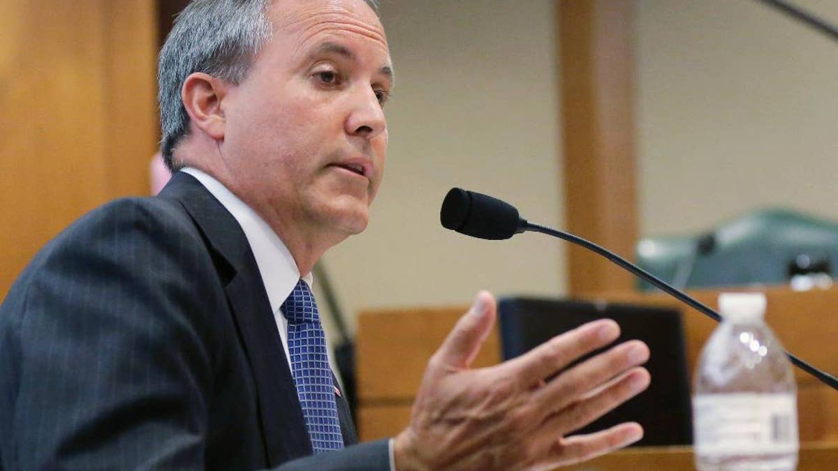 FILE - In this July 29, 2015, file photo, Texas Attorney General Ken Paxton speaks during a hearing in Austin, Texas. On the brink of bringing Paxton to trial on felony securities fraud charges, the government's prosecutors are threatening to bail out of the case unless they get paid. Paxton, a stockbroker and state lawmaker before being elected attorney general two years ago, was indicted for allegedly steering investors to a technology startup in 2011 without disclosing that he was being paid by the company. The trial is scheduled to start May 1, 2017. (AP Photo/Eric Gay, File)