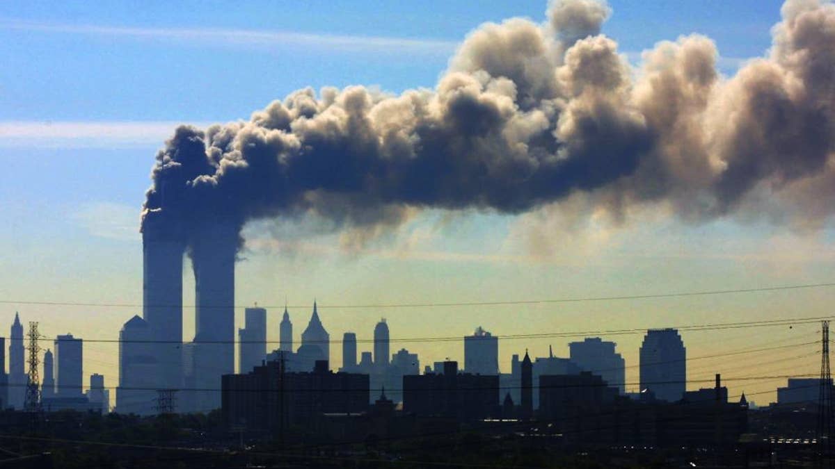 FILE - In this Sept. 11, 2001 file photo, as seen from the New Jersey Turnpike near Kearny, N.J., smoke billows from the twin towers of the World Trade Center in New York after airplanes crashed into both towers. Saudi Arabia and its allies are warning that legislation allowing the kingdom to be sued for the 9/11 attacks will have negative repercussions. The kingdom maintains an arsenal of tools to retaliate with, including curtailing official contacts, pulling billions of dollars from the U.S. economy, and enlisting its lockstep Gulf allies to scale back counterterrorism cooperation, investments and U.S. access to important regional air bases. (AP Photo/Gene Boyars, File)