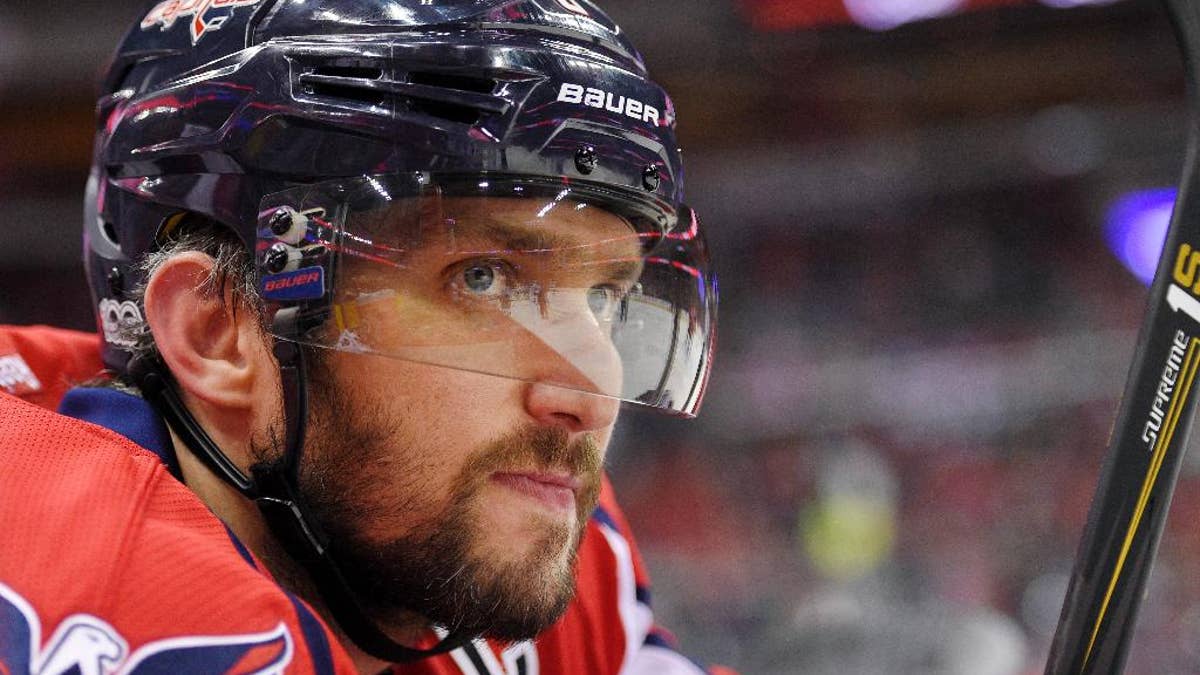 FILE - In this Tuesday, March 14, 2017, file photo, Washington Capitals left wing Alex Ovechkin (8), of Russia, looks on from the bench during the first period of an NHL hockey game against the Minnesota Wild in Washington. To get to their first Eastern Conference final in the past decade, Alex Ovechkin and the Washington Capitals will have to go through the Sidney Crosby and Pittsburgh Penguins, who have quite simply had their number in the playoffs. (AP Photo/Nick Wass, File)