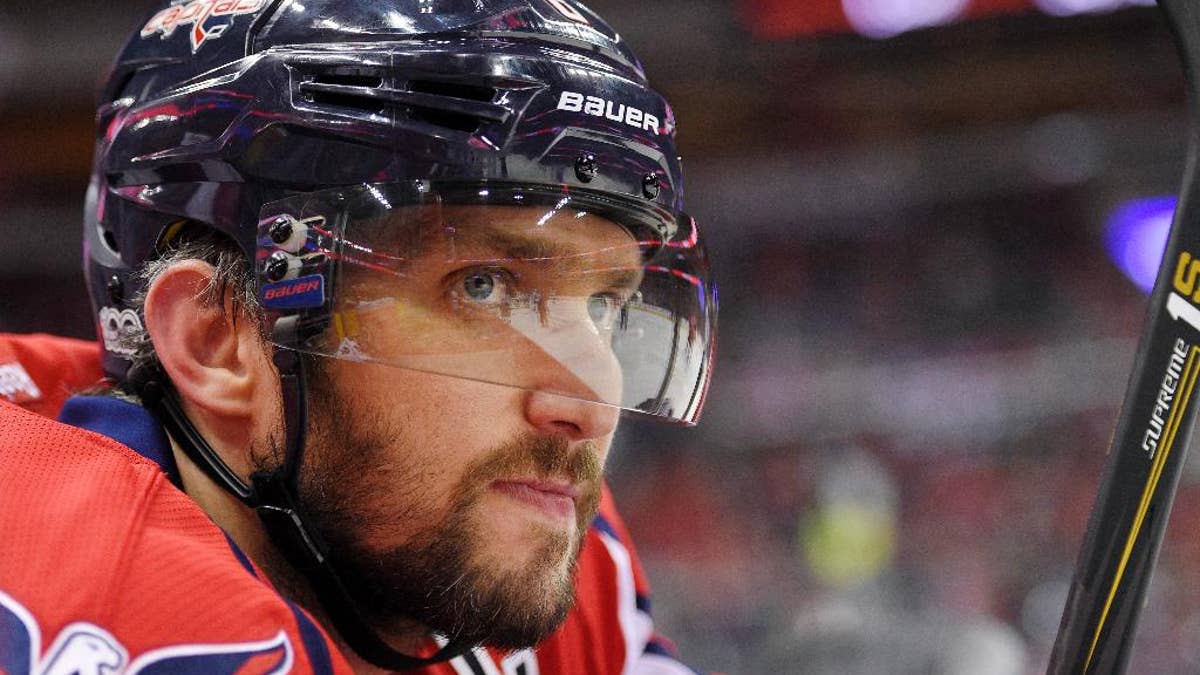 FILE - In this Tuesday, March 14, 2017, file photo, Washington Capitals left wing Alex Ovechkin (8), of Russia, looks on from the bench during the first period of an NHL hockey game against the Minnesota Wild in Washington. To get to their first Eastern Conference final in the past decade, Alex Ovechkin and the Washington Capitals will have to go through the Sidney Crosby and Pittsburgh Penguins, who have quite simply had their number in the playoffs. (AP Photo/Nick Wass, File)