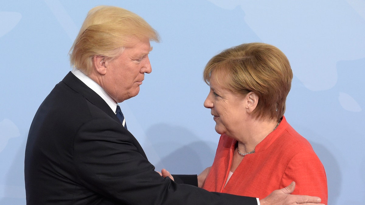U.S. President Donald Trump, left, is welcomed by German Chancellor Angela Merkel on the first day of the G-20 summit in Hamburg, northern Germany, Friday, July 7, 2017. The leaders of the group of 20 meet July 7 and 8. (AP Photo/Jens Meyer)