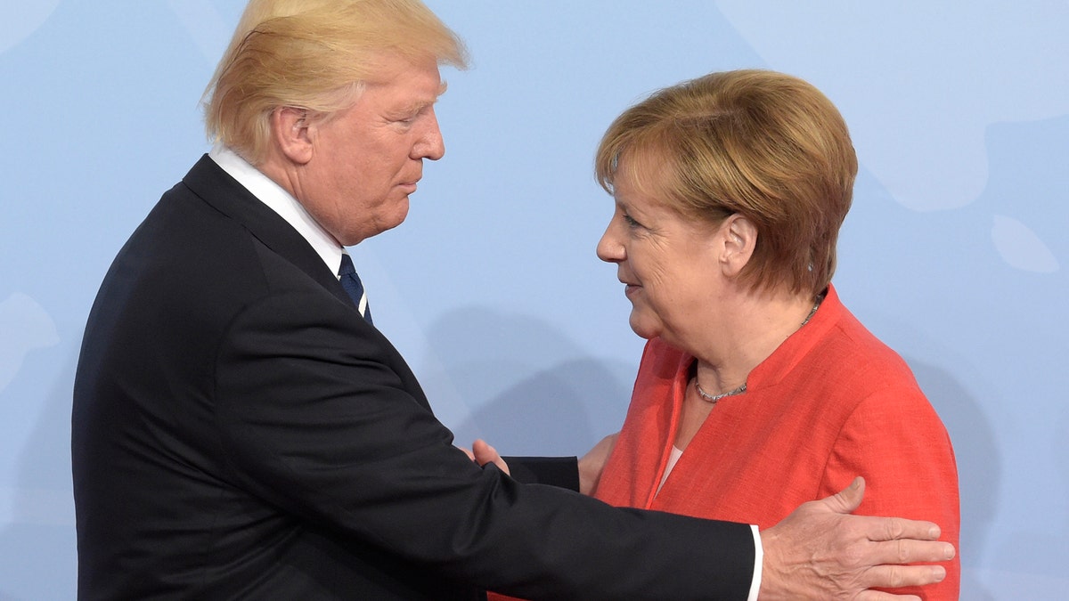 U.S. President Donald Trump, left, is welcomed by German Chancellor Angela Merkel on the first day of the G-20 summit in Hamburg, northern Germany, Friday, July 7, 2017. The leaders of the group of 20 meet July 7 and 8. (AP Photo/Jens Meyer)