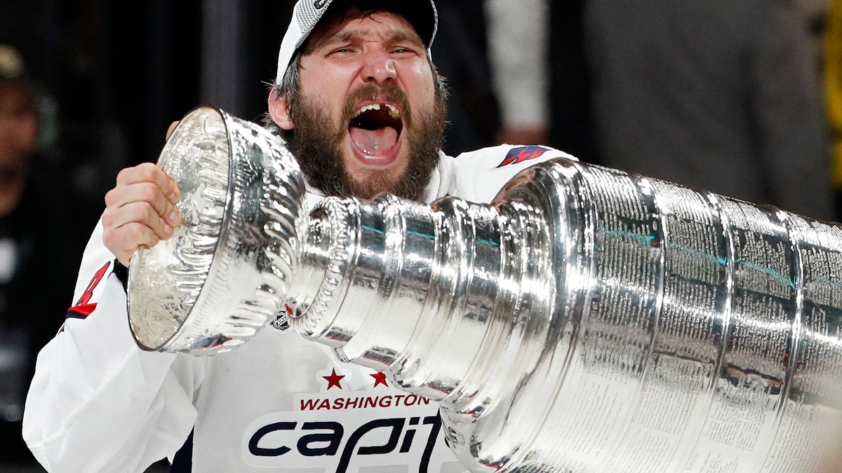 Washington Capitals left wing Alex Ovechkin, of Russia, hoists the Stanley Cup after the Capitals defeated the Golden Knights in Game 5 of the NHL hockey Stanley Cup Finals Thursday, June 7, 2018, in Las Vegas. (AP Photo/John Locher)